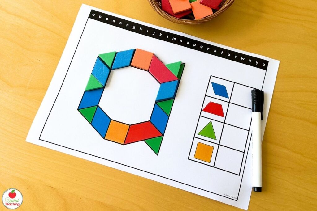 Colorful pattern blocks forming the lowercase letter a on a kindergarten alphabet pattern block mat, with a recording table for counting each shape used