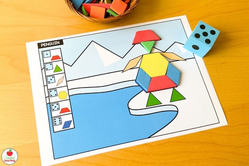 Roll and build penguin pattern block mat with a polar landscape scene, where students roll a die and place the matching shape until the penguin is complete