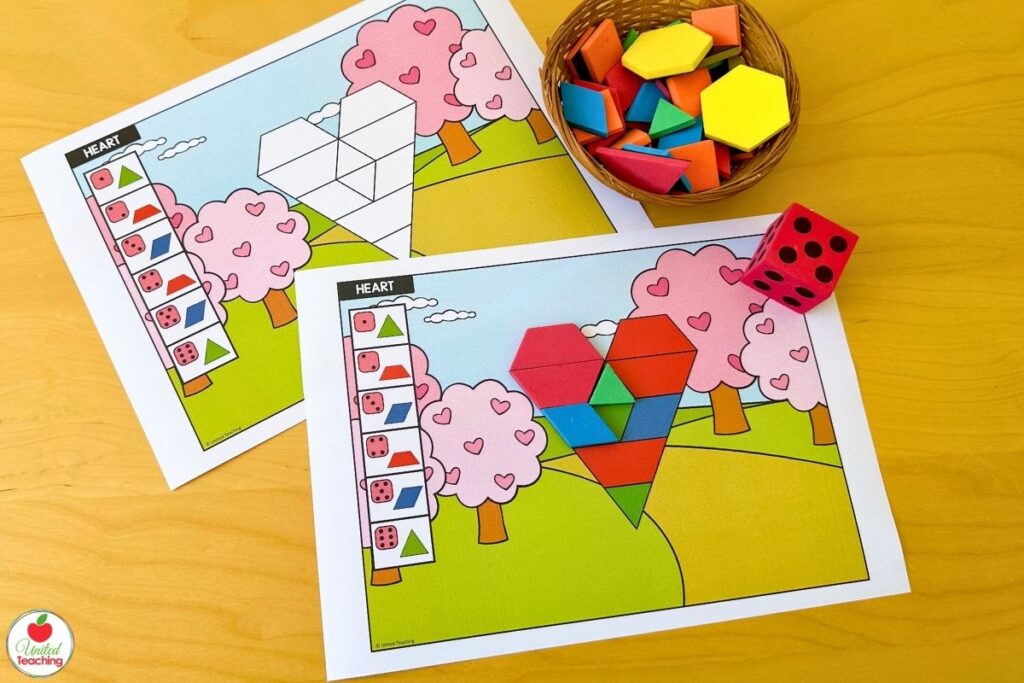 Two Valentine's Day heart roll and build pattern block mats showing a blank template alongside a coloured version, where students roll a die and place the matching shape to build the heart