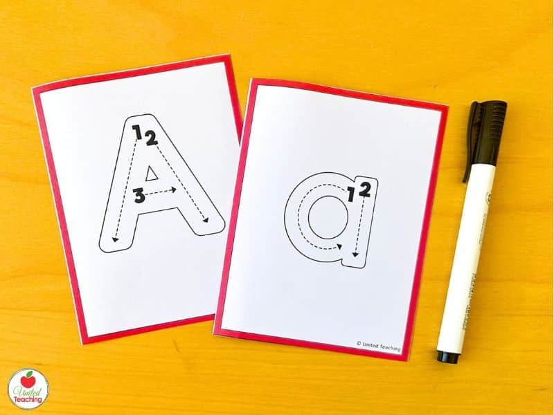 Uppercase A and lowercase a letter formation task cards with dashed tracing paths and stroke numbers, shown with a dry-erase marker for reusable practice