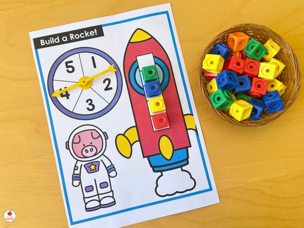 Build a Rocket activity mat for numbers 1-5 with a spinner and math cubes stacked on the rocket body for counting practice