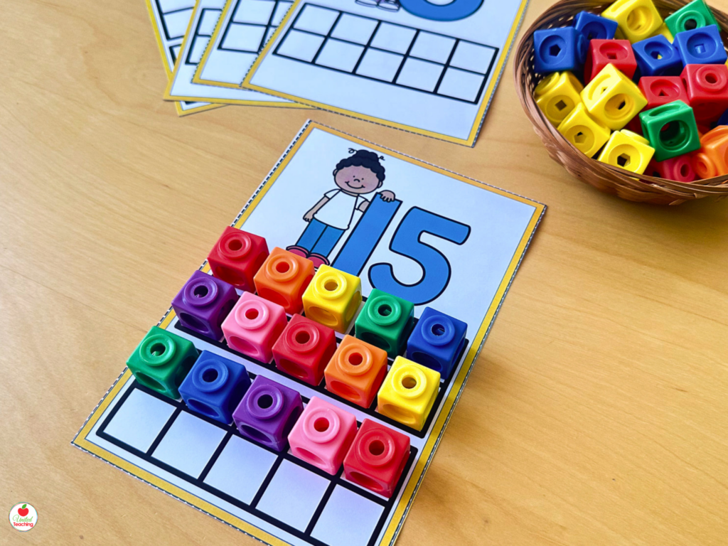 Number 15 activity mat with math cubes filling a double ten frame grid to show the teen number structure of ten and five more