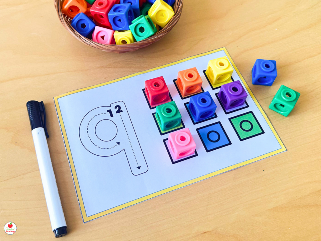 Number sense activity mat for number 9 with colorful math cubes placed in a grid alongside a number tracing guide