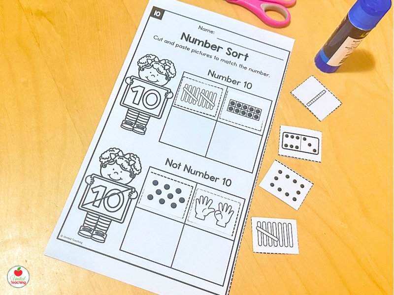 Number sort cut-and-paste worksheet where students sort number representations into Number 1 and Not Number 1 categories for kindergarten subitizing practice