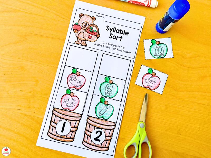 Syllable Sort worksheet with students cutting and pasting apples into one and two syllable baskets