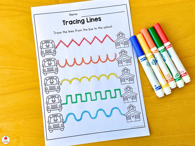 Tracing Lines worksheet with five colorful paths traced from a school bus to the schoolhouse
