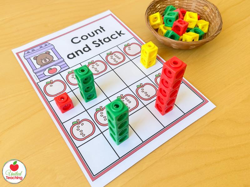 Apple Count and Stack mat with red green and yellow math cube towers matching apples showing seeds