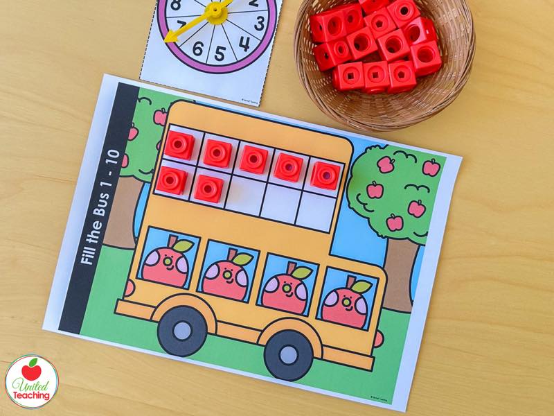 Apple Fill the Bus ten frame mat for numbers 1 to 10 with red math cubes and a numbers 1 to 10 spinner