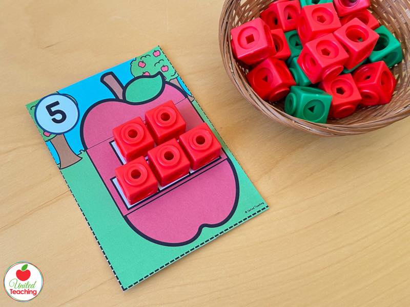 Apple one to one correspondence task card for number 5 with red math cubes placed on the apple