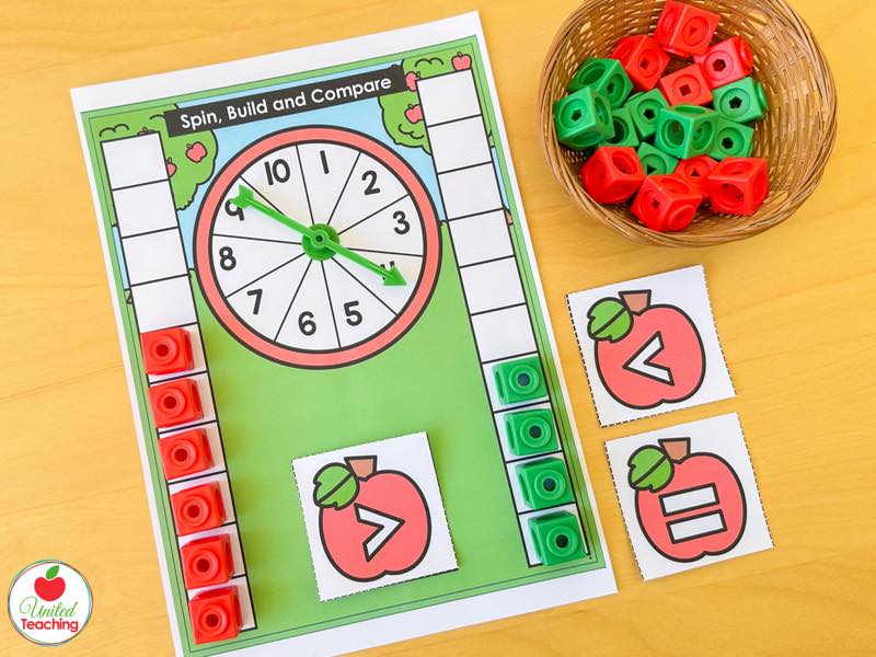 Apple Spin Build and Compare mat with a 1 to 10 spinner, cube columns and greater than symbol cards