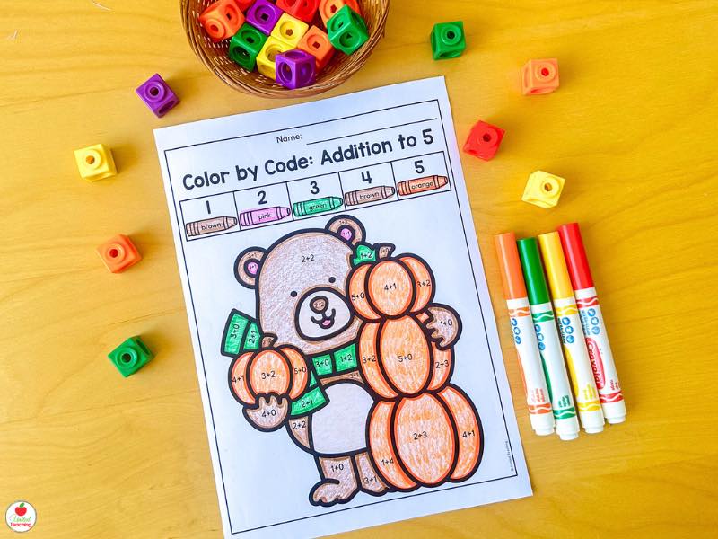 Fall color by code addition to 5 worksheet for kindergarten with a bear holding pumpkins