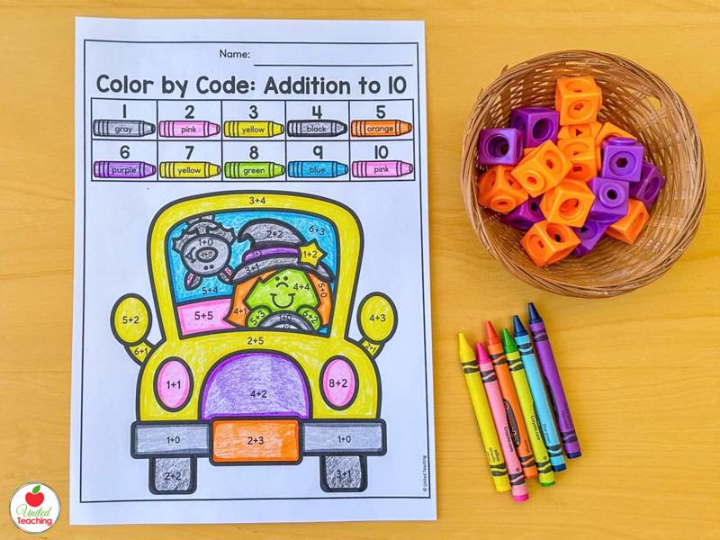 Halloween color by code addition to 10 worksheet with a colored school bus and witch