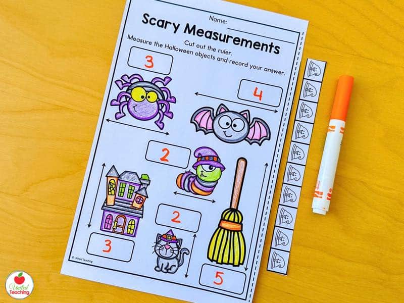Halloween measurement worksheet with a cut out ruler and answers recorded for each object