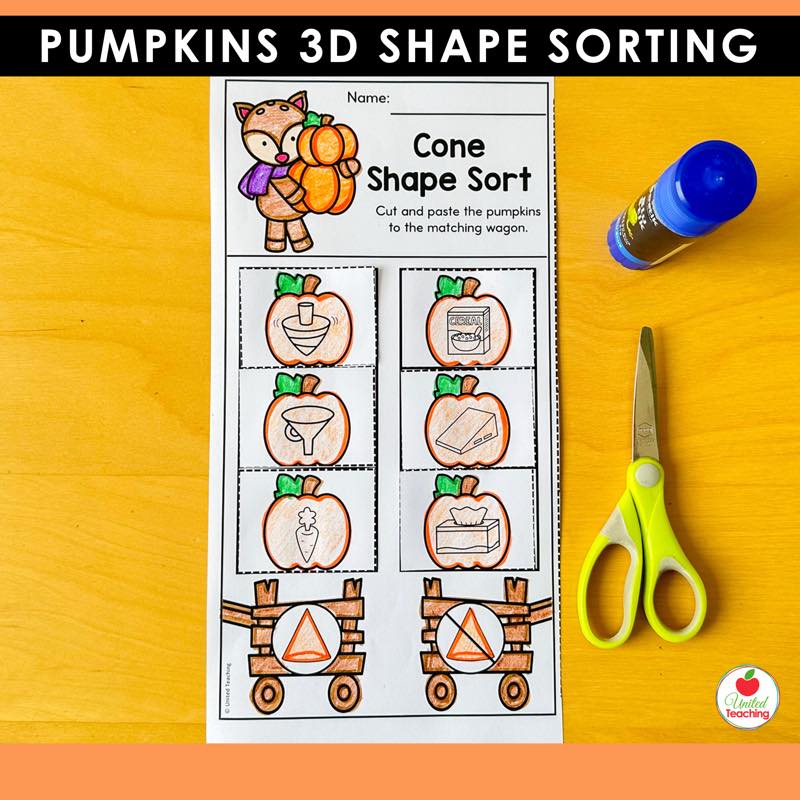 Pumpkins cone shape sorting worksheet with pumpkin picture cards and wagons, scissors and glue on a desk