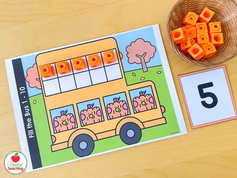 Pumpkin Fill the Bus ten frame mat for 1 to 10 with five orange math cubes and a number 5 card