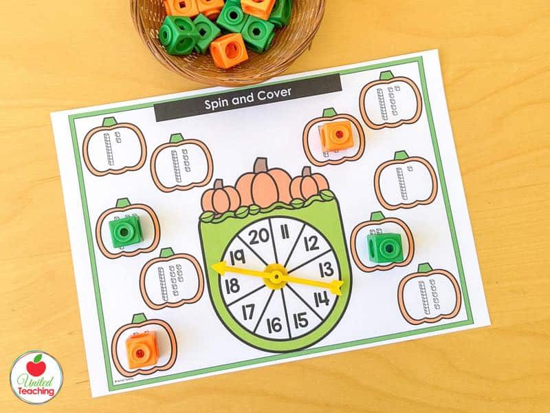 Pumpkin Spin and Cover mat for 11 to 20 with base ten block pumpkins and orange and green math cubes