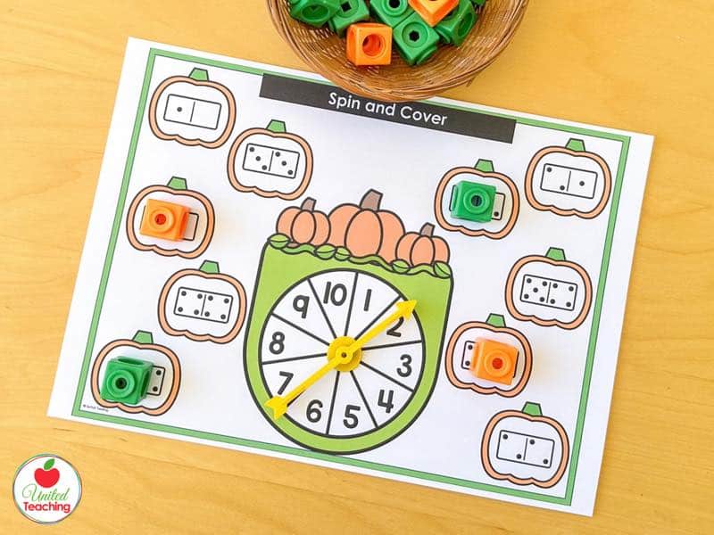 Pumpkin Spin and Cover mat for 1 to 10 with domino pumpkins and orange and green math cubes