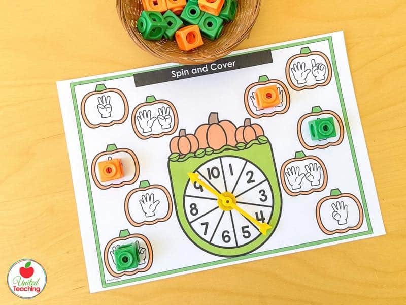 Pumpkin Spin and Cover mat for 1 to 10 with finger counting pumpkins and orange and green math cubes