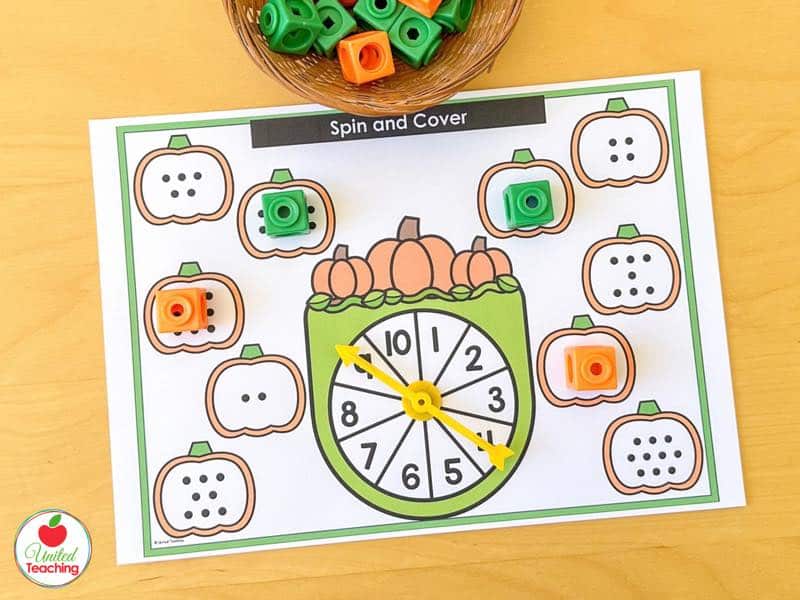 Pumpkin Spin and Cover mat for 1 to 10 with subitizing dot pumpkins and orange and green math cubes