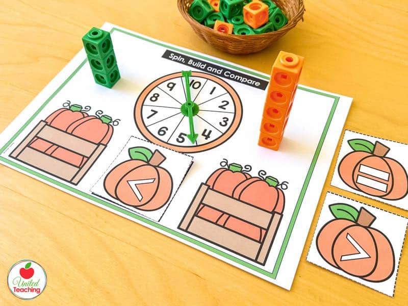 Pumpkin Spin Build and Compare mat with pumpkin crates, a 1 to 10 spinner, and math cube towers