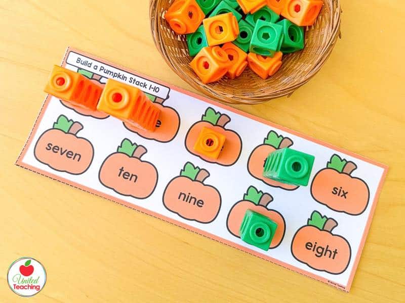 Build a Pumpkin Stack mat with number word pumpkins and math cube towers built to match