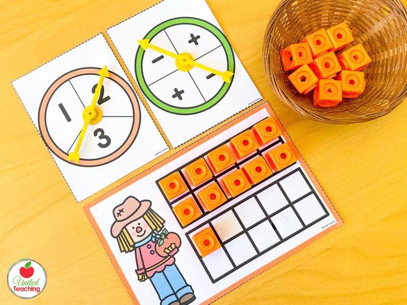 Pumpkin ten frame building task card with a 1 to 3 spinner, a plus minus spinner, and orange math cubes