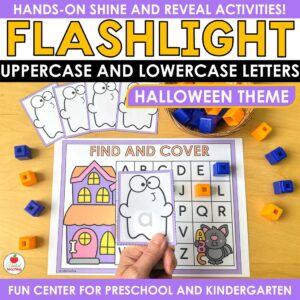 Halloween Alphabet Flashlight activity with a ghost card lit to show a lowercase a over a letter mat