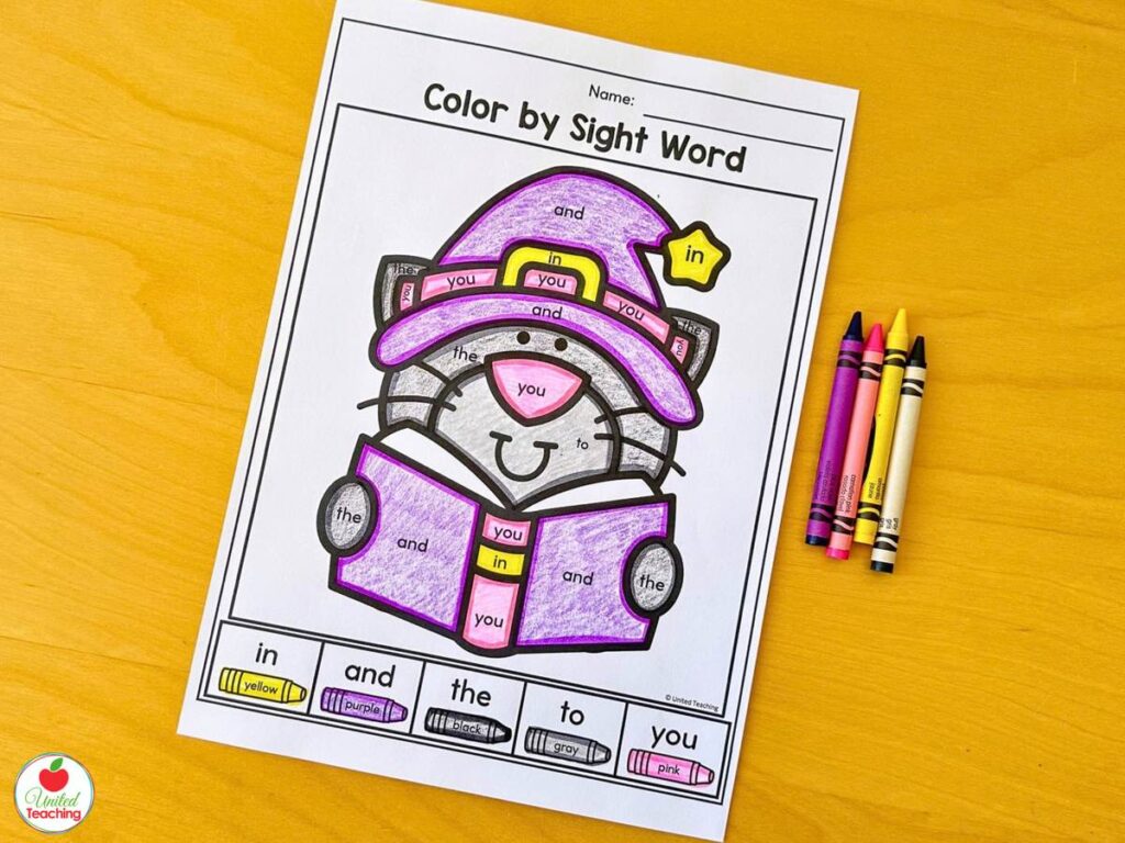 Halloween color by sight word worksheet with a cat in a witch hat reading a book
