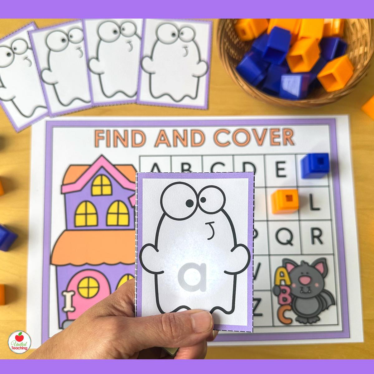 Halloween Alphabet Flashlight ghost card held up to reveal lowercase a in front of an uppercase letter mat