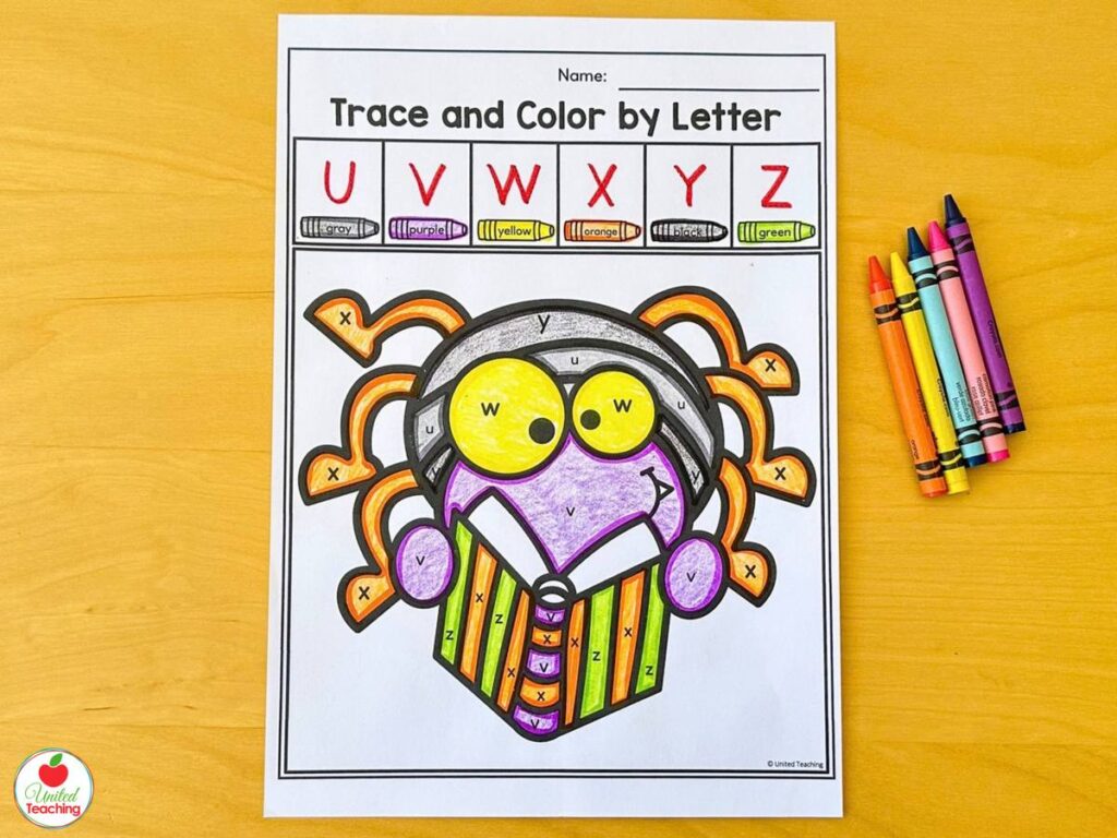 Halloween trace and color by letter worksheet for letters U to Z with a spider reading a book